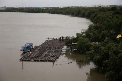 High angle view of river by trees against sky