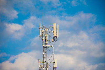 Low angle view of communications tower against sky