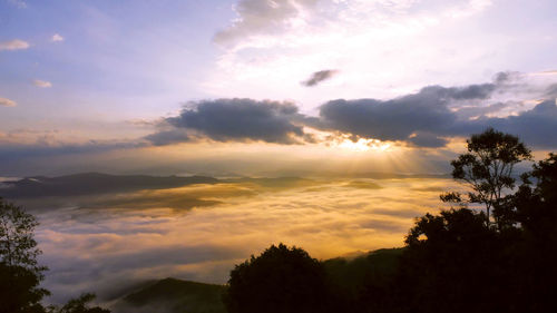 Scenic view of silhouette mountains against sky at sunset