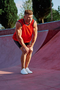 Side view of man exercising on field