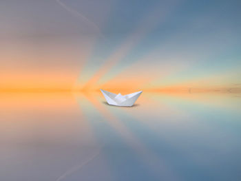 Scenic view of paper against sky during sunset