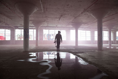 Silhouette man walking in corridor