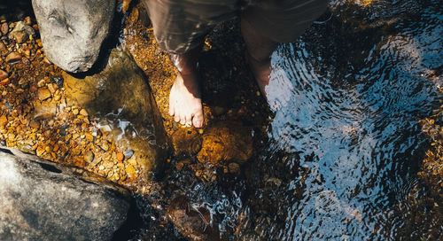 Low section of person standing on rock