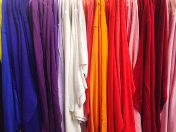 Full frame shot of multi colored clothes hanging in store