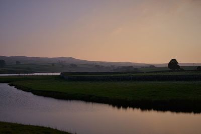 Scenic view of lake against sky during sunset