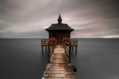 Pier over sea against sky