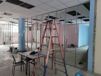 Empty chairs and tables in building