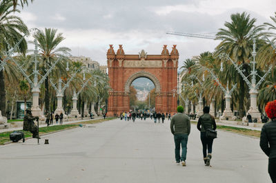 People walking in front of historical building