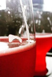 Close-up of red wine on glass