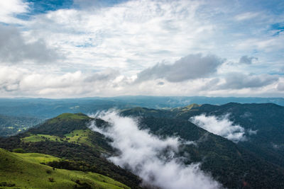 Scenic view of waterfall against sky