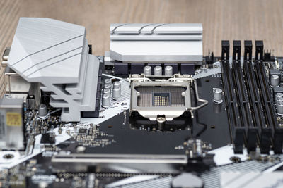 A modern desktop motherboard in black color with a visible socket 1200 for the cpu, memory  ddr4.