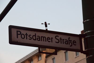 Low angle view of information sign against clear sky