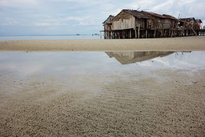 View of beach against cloudy sky