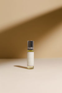 Close-up of perfume on colored background