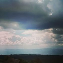 Scenic view of landscape against cloudy sky