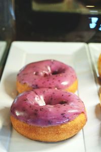 High angle view of donuts in plate seen through glass