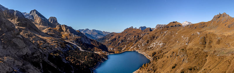 Panoramic view of rocky mountains against clear sky