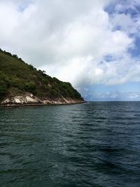 View of calm sea against cloudy sky