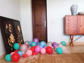 Multi colored balloons on table at home