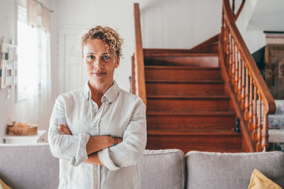 Portrait of mature woman standing at home