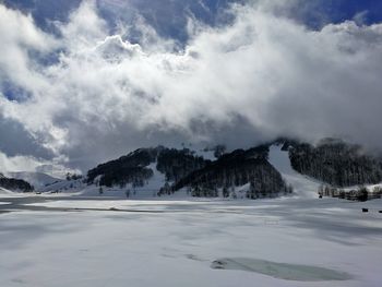 Scenic view of snowcapped mountains against sky