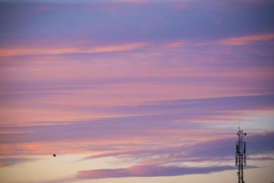 Low angle view of silhouette tower against sky during sunset