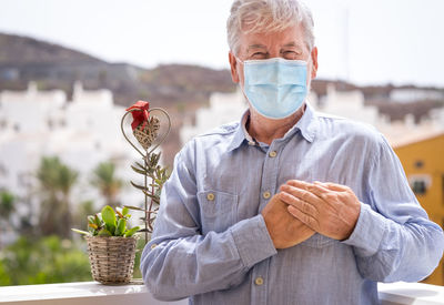 Portrait of man holding basket while standing outdoors