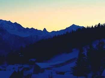 Scenic view of silhouette mountains against sky at sunset