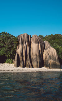 Scenic view of rock against clear blue sky