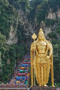 Statue of buddha against trees