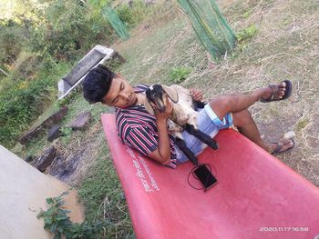 High angle view of man photographing woman using mobile phone