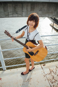 Young woman playing guitar