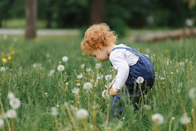 Side view of baby girl on field