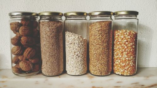 Close-up of food in glass jars on table