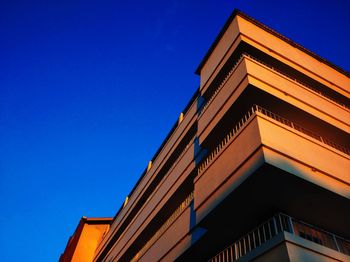 Low angle view of building against clear blue sky