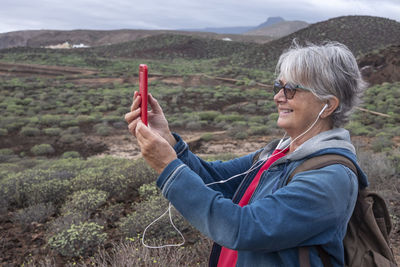 Portrait of woman with umbrella on mountain