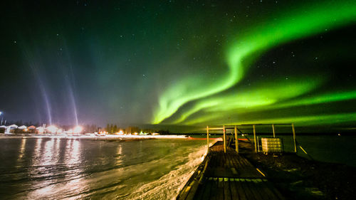 Panoramic view of illuminated landscape against sky at night