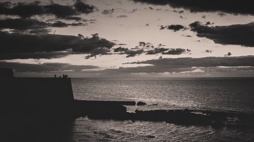 Scenic view of sea against sky at sunset