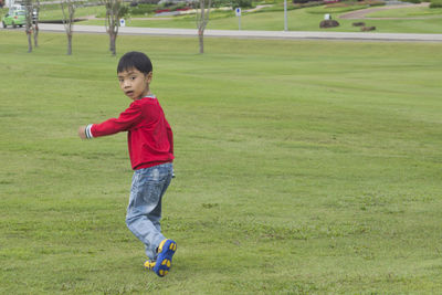 Portrait of boy running on field