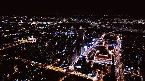 Illuminated view of people at night