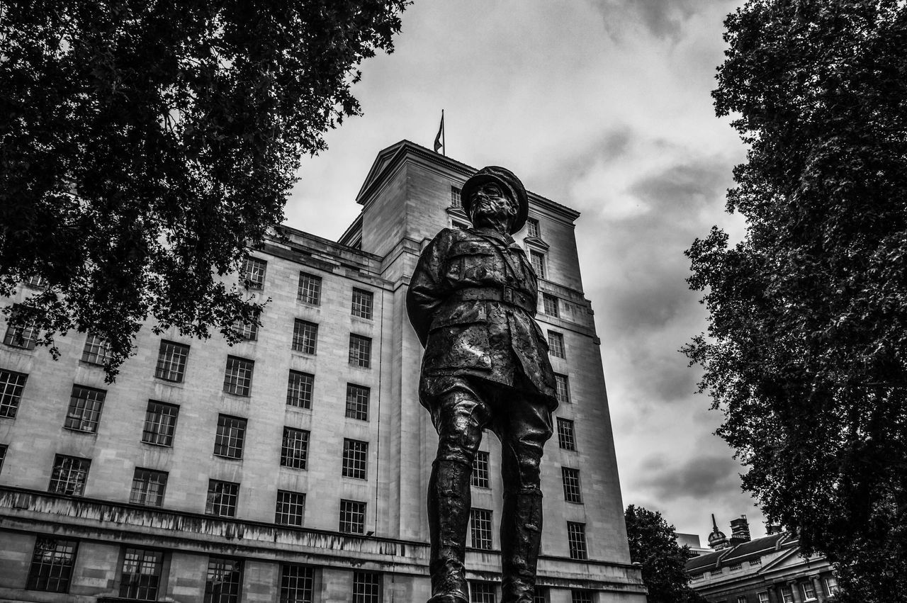 LOW ANGLE VIEW OF STATUE AGAINST BUILDINGS IN CITY