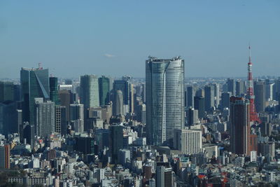 Aerial view of buildings in city against sky in tokyo