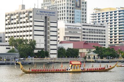 Buildings by river in city