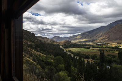 Scenic view of landscape and mountains against sky