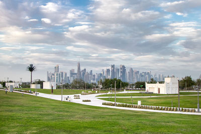 View of city buildings against cloudy sky