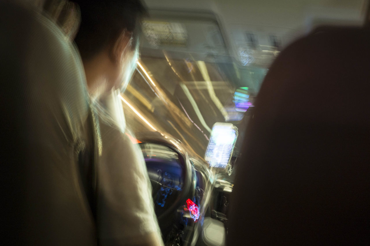 REAR VIEW OF MAN IN CAR