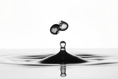 Close-up of drop falling on water surface