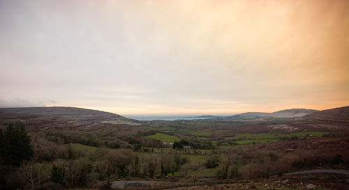 Scenic view of mountains against cloudy sky