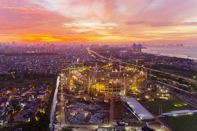 High angle view of illuminated buildings against sky during sunset