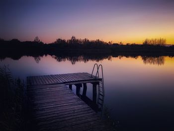 Scenic view of lake against sky during sunset